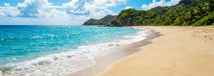 Turquoise ocean waves along a sandy tropical beach with lush hills